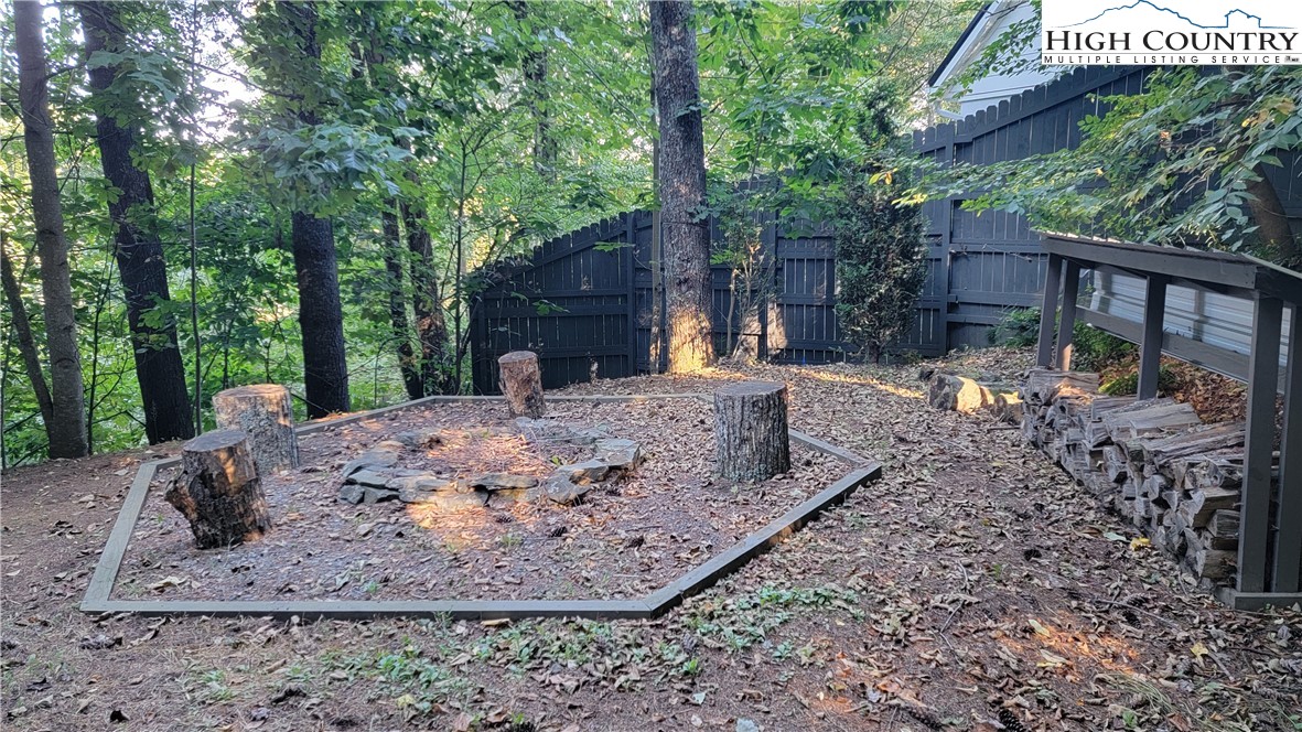 526 Hidden Valley Circle Boone, NC 28607 - Photo 26 of 29 a view of a backyard with large trees and wooden fence