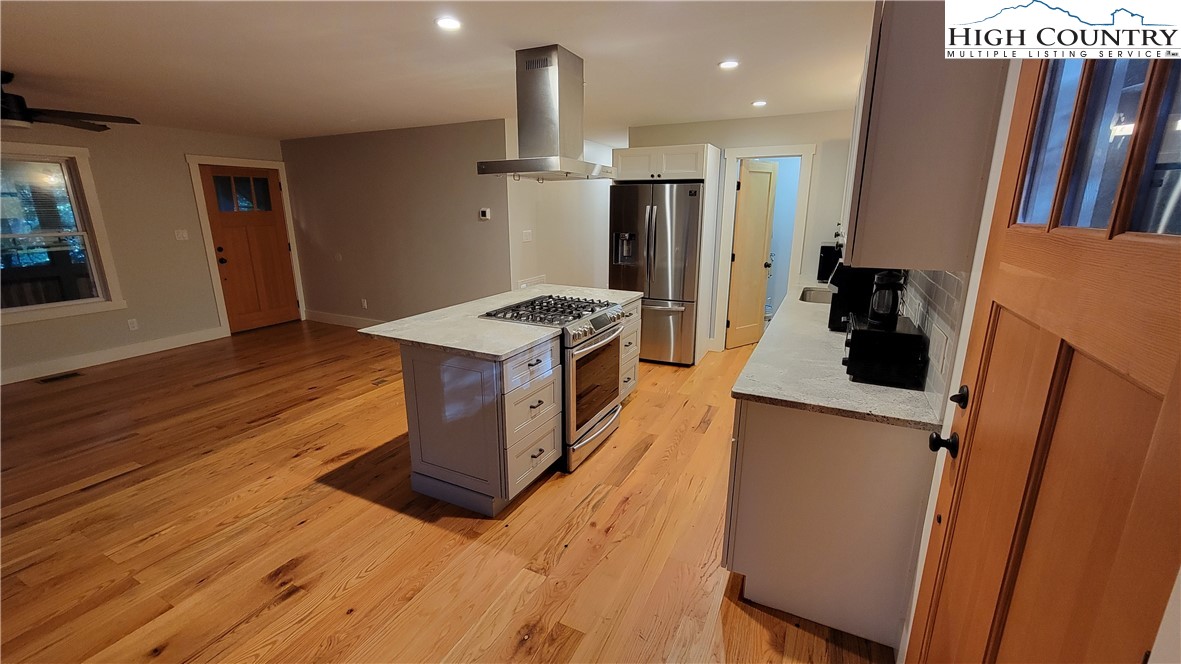 526 Hidden Valley Circle Boone, NC 28607 - Photo 5 of 29 a kitchen with a sink a refrigerator and wooden floor