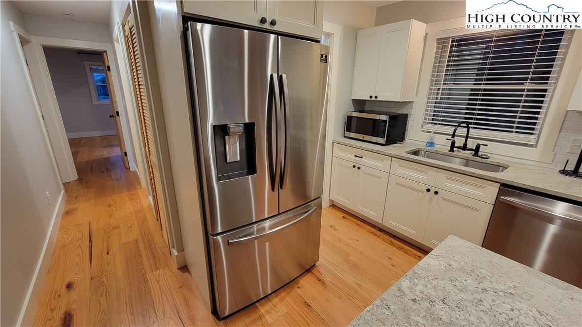 526 Hidden Valley Circle Boone, NC 28607 - Photo 7 of 29 a kitchen with granite countertop a refrigerator and a sink