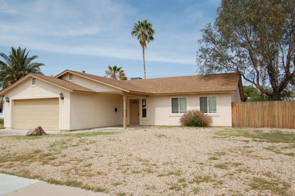 2408 East Cactus Road Phoenix, AZ 85032 - Photo 1 of 4 a front view of a house with a yard and garage