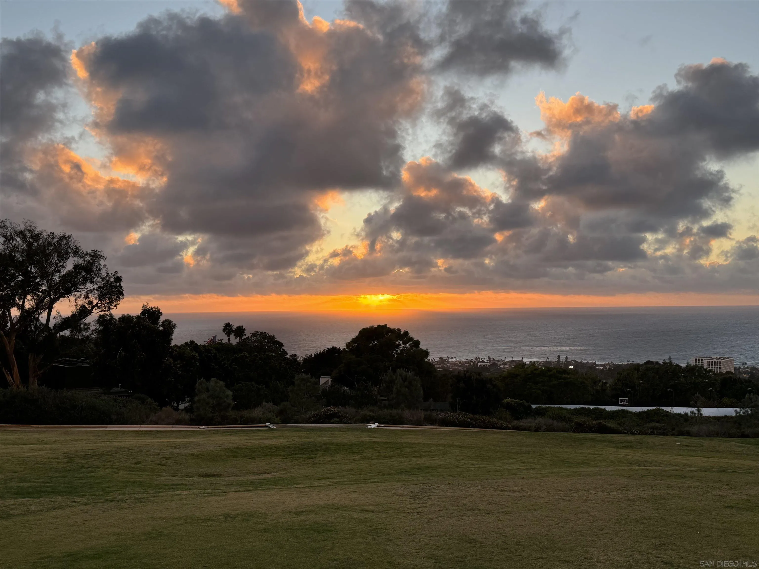 7138 Romero Loop, Unit 3 La Jolla, CA 92037 - Photo 2 of 13 a view of a lake and sunset