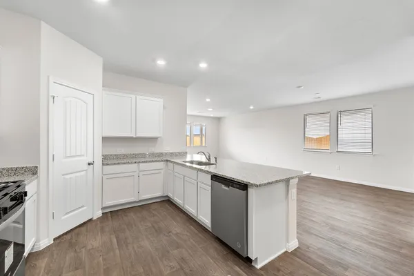 a kitchen with stainless steel appliances granite countertop a sink and a stove top oven