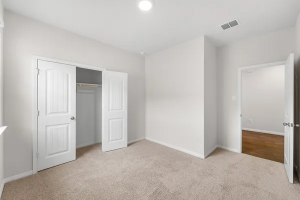 a view of an empty room and closet area