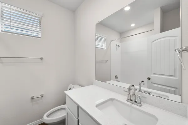 a bathroom with a sink toilet and vanity
