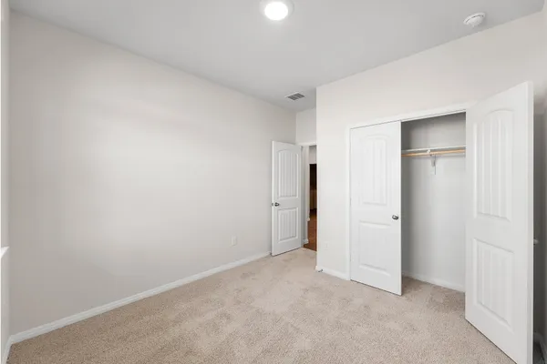 an empty room with closet area