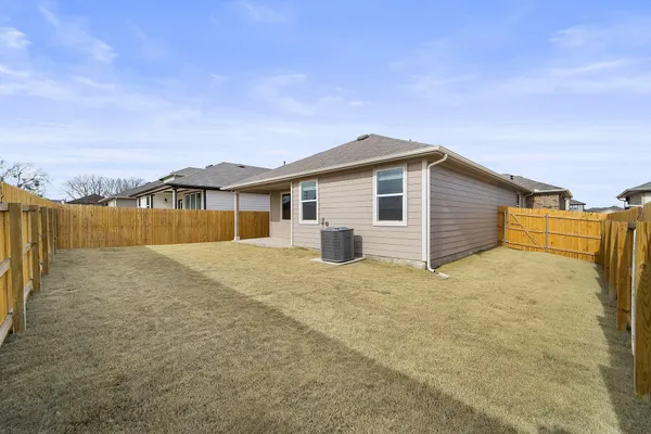 a view of a house with a wooden fence