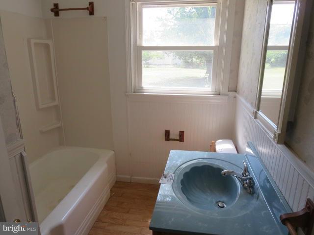 1616 Walnut Road St. Leonard, MD 20685 - Photo 8 of 11 a bathroom with a sink and bathtub with window