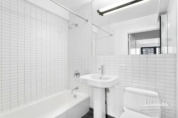 a bathroom with a sink a toilet and bathtub