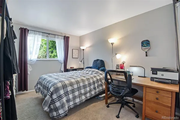 a bedroom with a bed and a desk