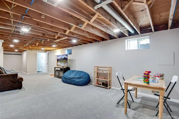 a view of a room with furniture and a chandelier