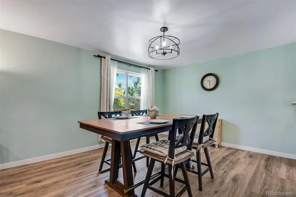 a view of a dining room with furniture window and wooden floor