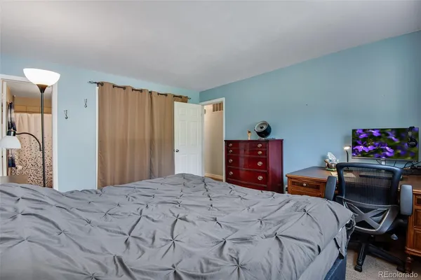 a bedroom with a bed and a chandelier