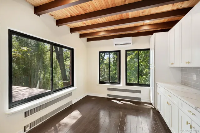 a view of a hardwood floor and a large window