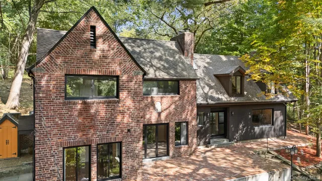 a view of house with yard and outdoor seating