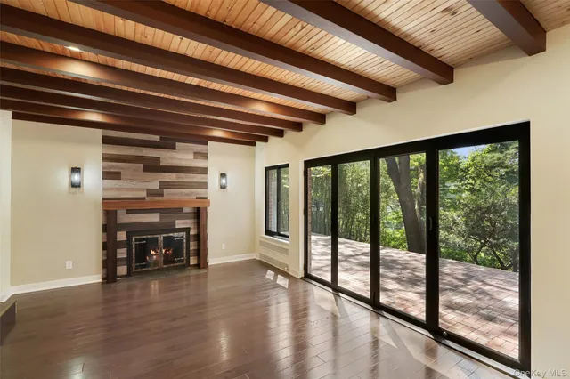 a view of a livingroom with furniture wooden floor and windows