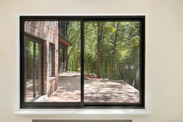 a view of kitchen with granite countertop cabinets and window