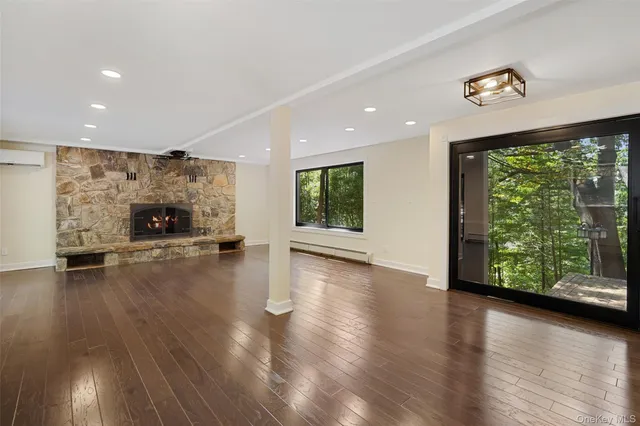 a view of a hallway with wooden floor and windows