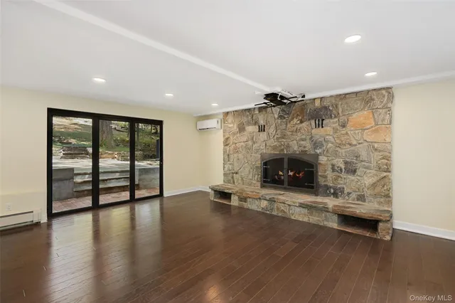 a view of a livingroom with wooden floor and window