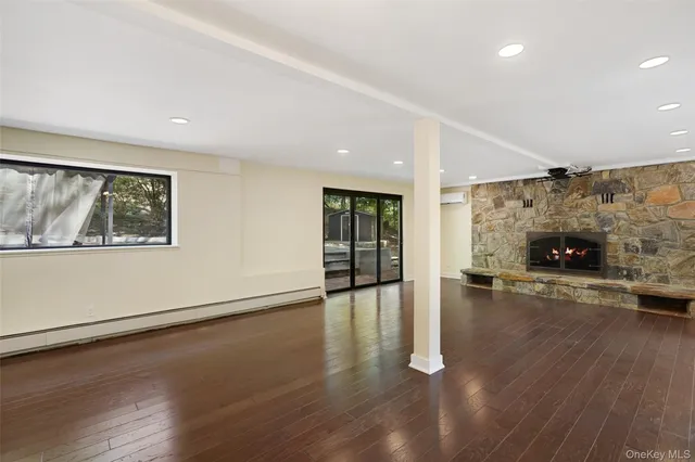 an empty room with wooden floor and fireplace