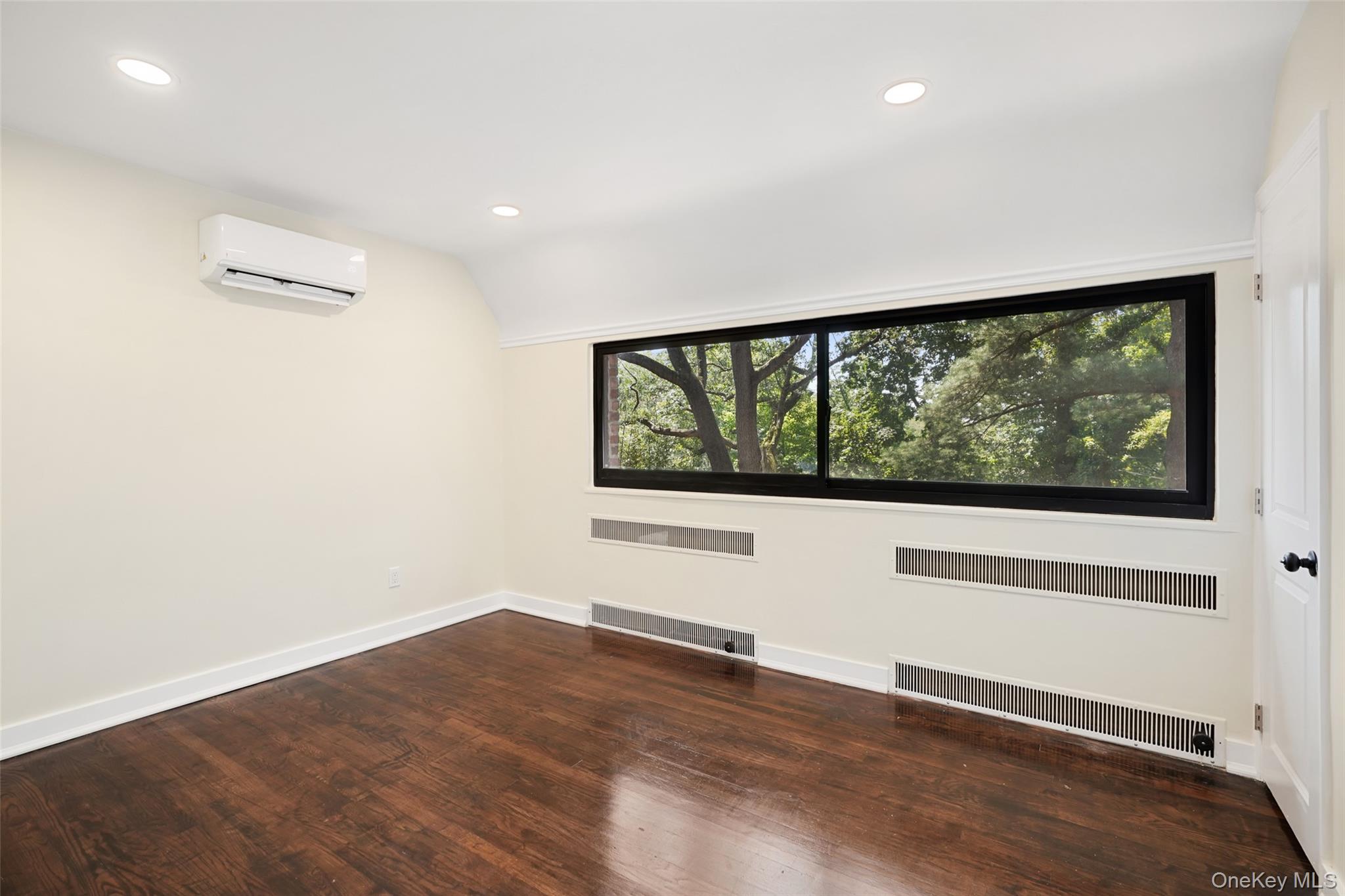 27 Hardscrabble Road Briarcliff Manor, NY 10510 - Photo 24 of 43 an empty room with wooden floor and windows