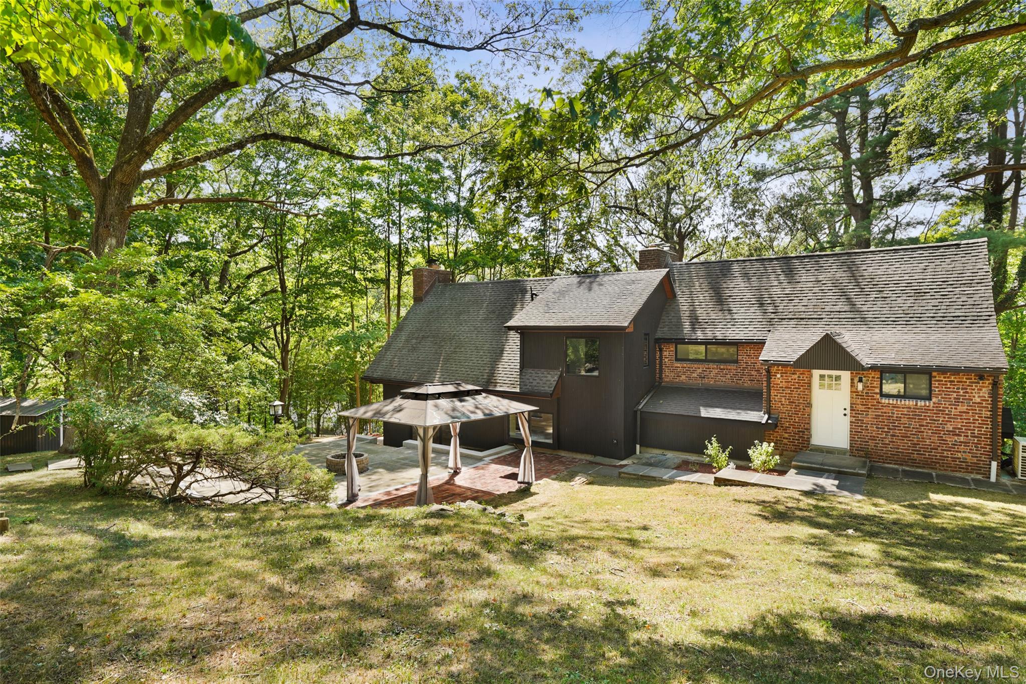 27 Hardscrabble Road Briarcliff Manor, NY 10510 - Photo 27 of 43 a backyard of a house with table and chairs