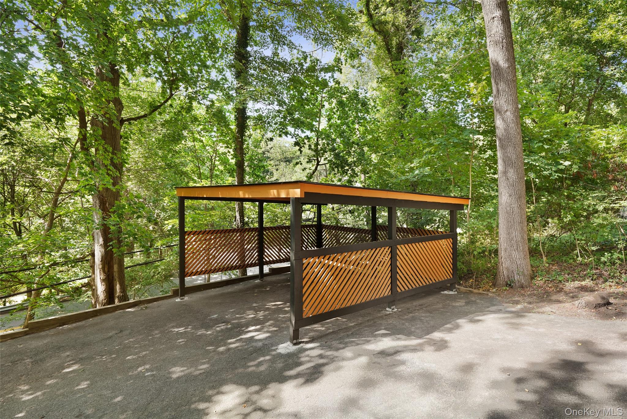 27 Hardscrabble Road Briarcliff Manor, NY 10510 - Photo 29 of 43 a view of a backyard with a large tree and wooden fence