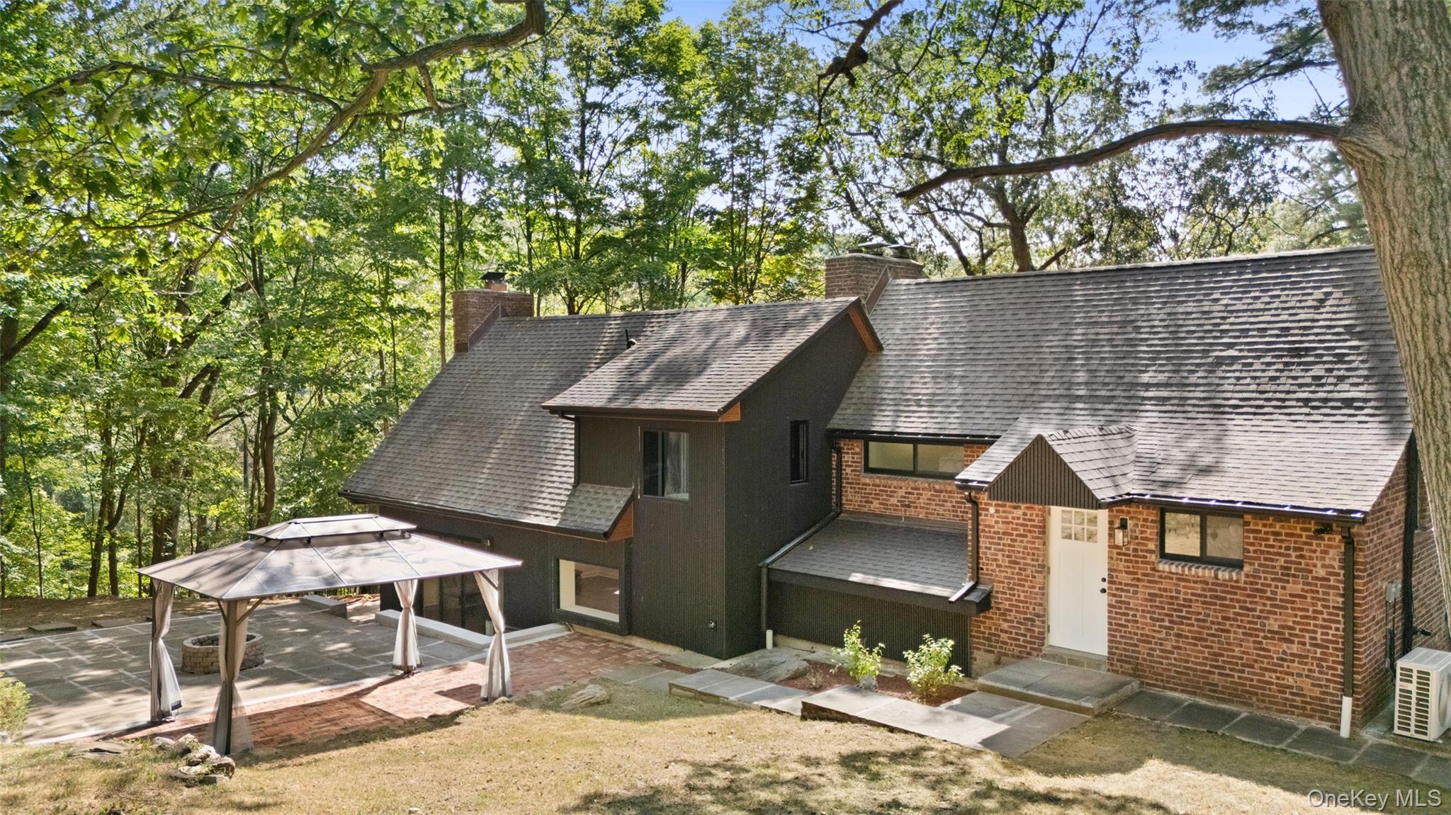 27 Hardscrabble Road Briarcliff Manor, NY 10510 - Photo 38 of 43 a backyard of a house with table and chairs