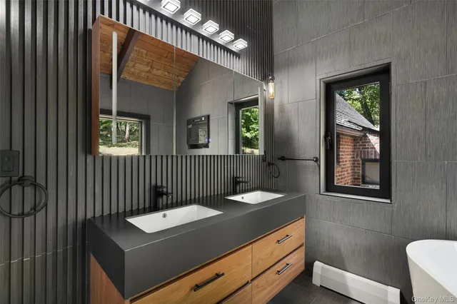 a bathroom with a sink a mirror and a toilet