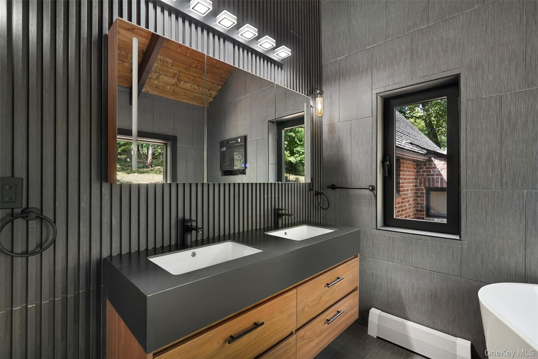 27 Hardscrabble Road Briarcliff Manor, NY 10510 - Photo 5 of 43 a bathroom with a sink a mirror and a toilet
