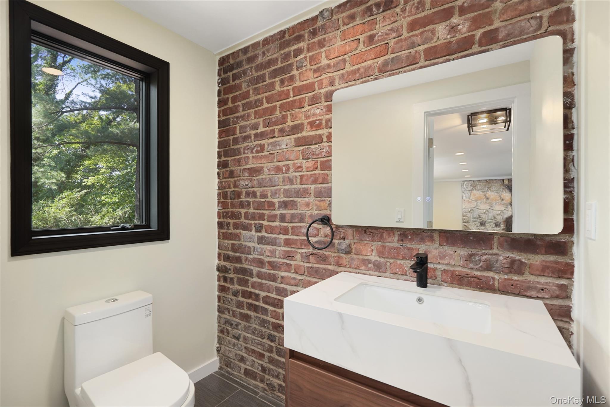 27 Hardscrabble Road Briarcliff Manor, NY 10510 - Photo 7 of 43 a bathroom with a sink a toilet and mirror