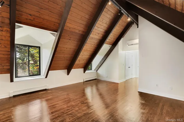 a view of an entryway with wooden floor and door
