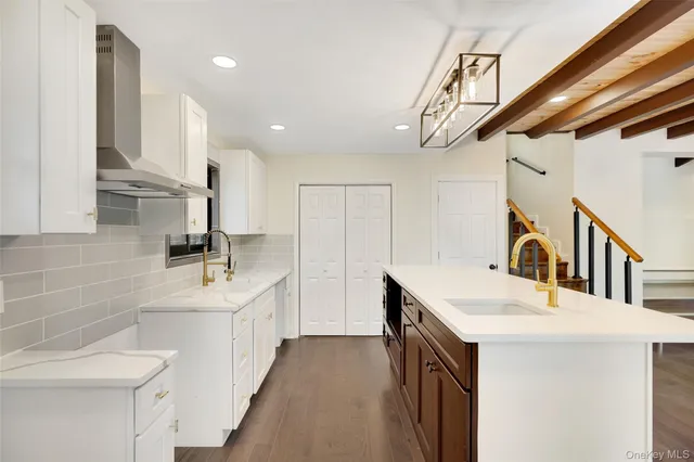 a kitchen with stainless steel appliances a sink a stove and cabinets
