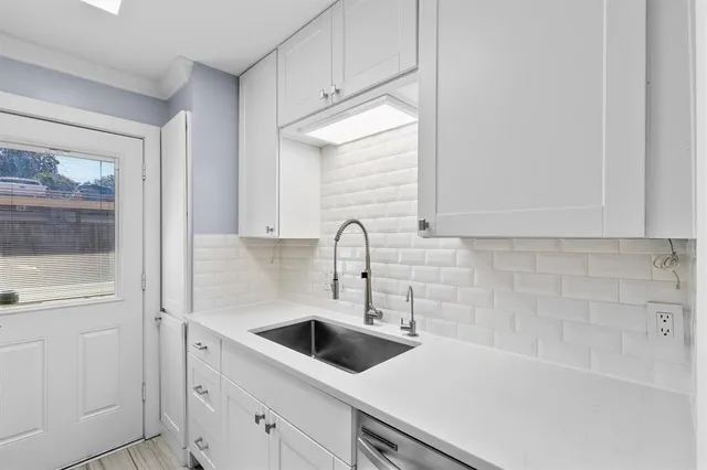 a kitchen with a sink and a stove top oven