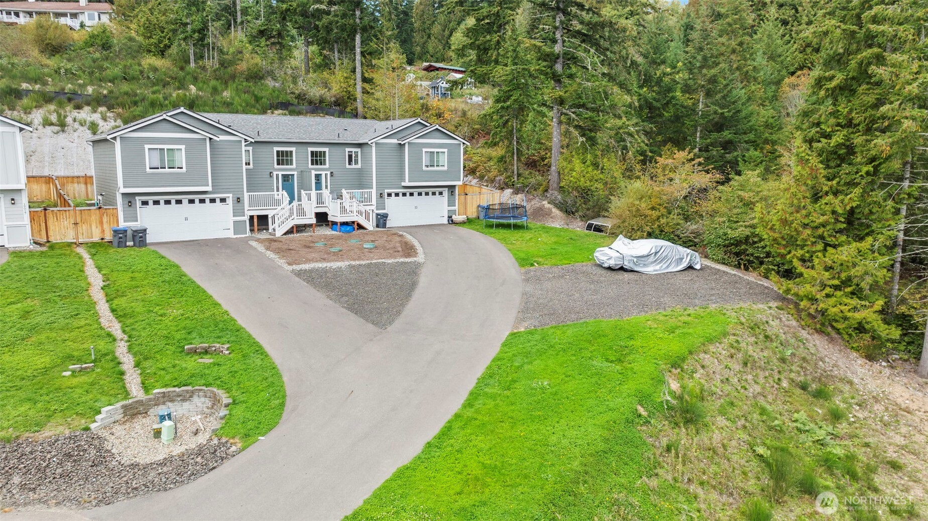 19019 Highway 3, Unit B Allyn, WA 98524 - Photo 2 of 23 a front view of a house with a yard and trees