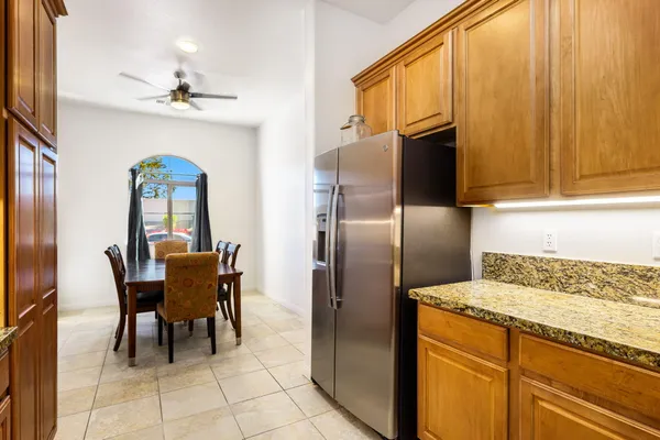 a kitchen with stainless steel appliances granite countertop a refrigerator and a stove top oven