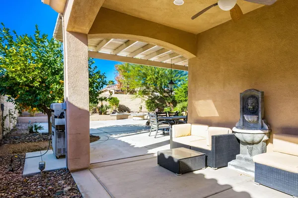 a building outdoor space with patio furniture and potted plants