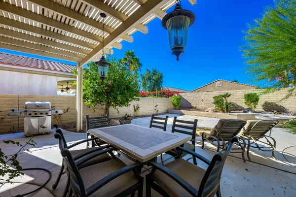 a roof deck with table and chairs