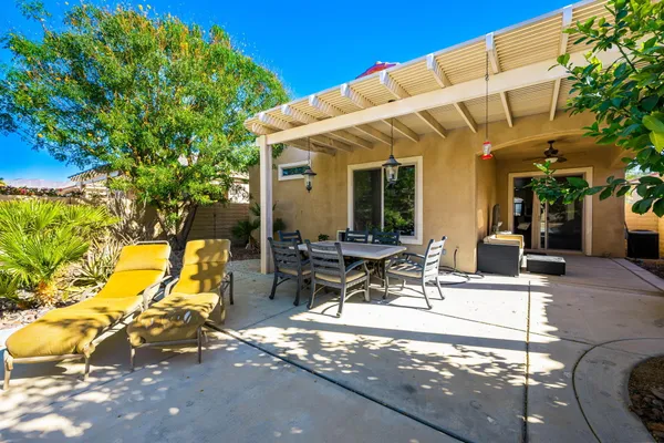 a view of a patio with table and chairs and potted plants