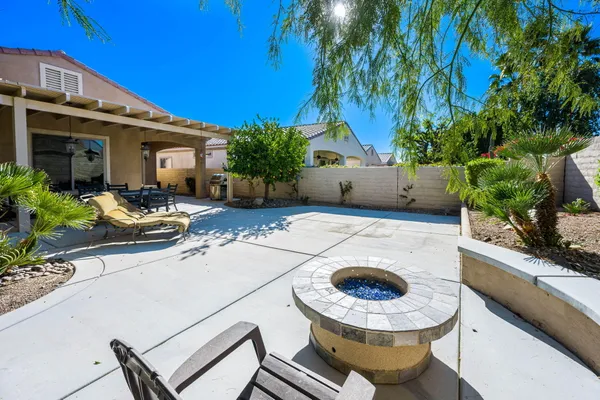 a view of a house with swimming pool and sitting area