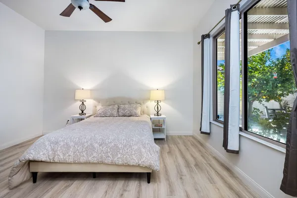 a bedroom with a bed and wooden floor