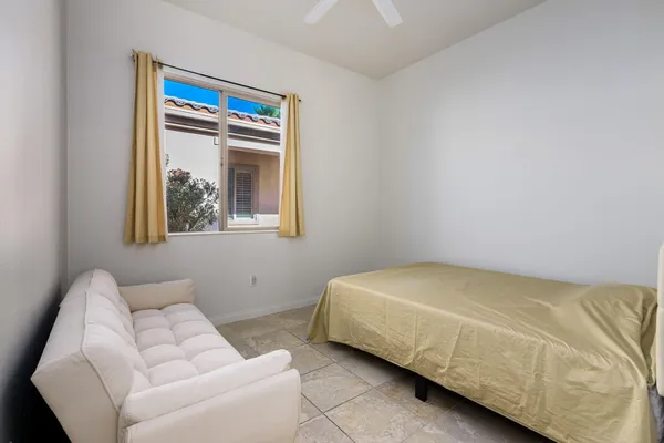 a bedroom with a bed and a couch