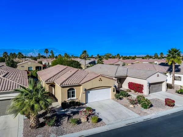 an aerial view of multiple houses with a city view