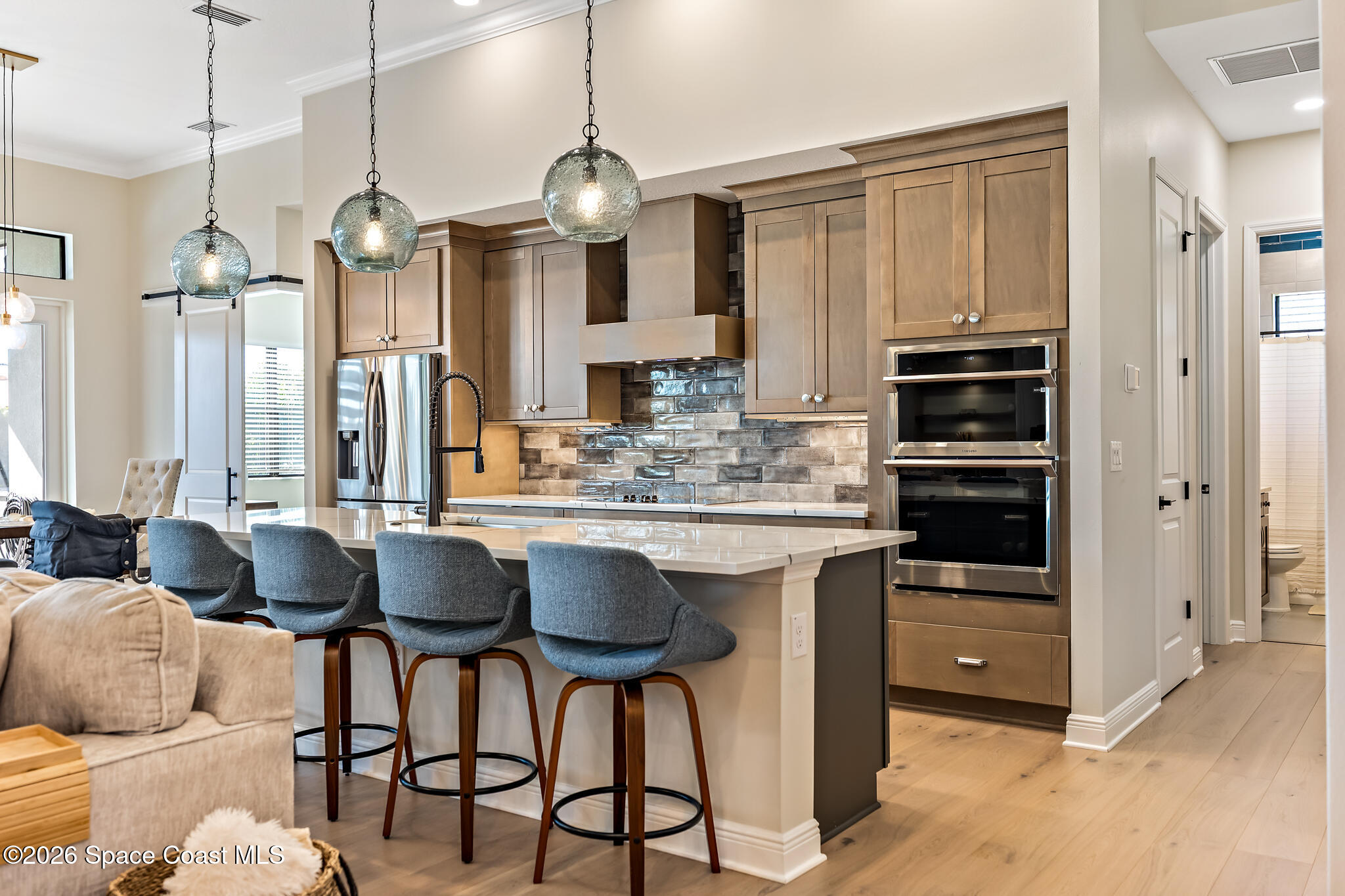 4055 Domain Court Melbourne, FL 32934 - Photo 10 of 49 a kitchen with stainless steel appliances kitchen island granite countertop a table chairs sink and cabinets