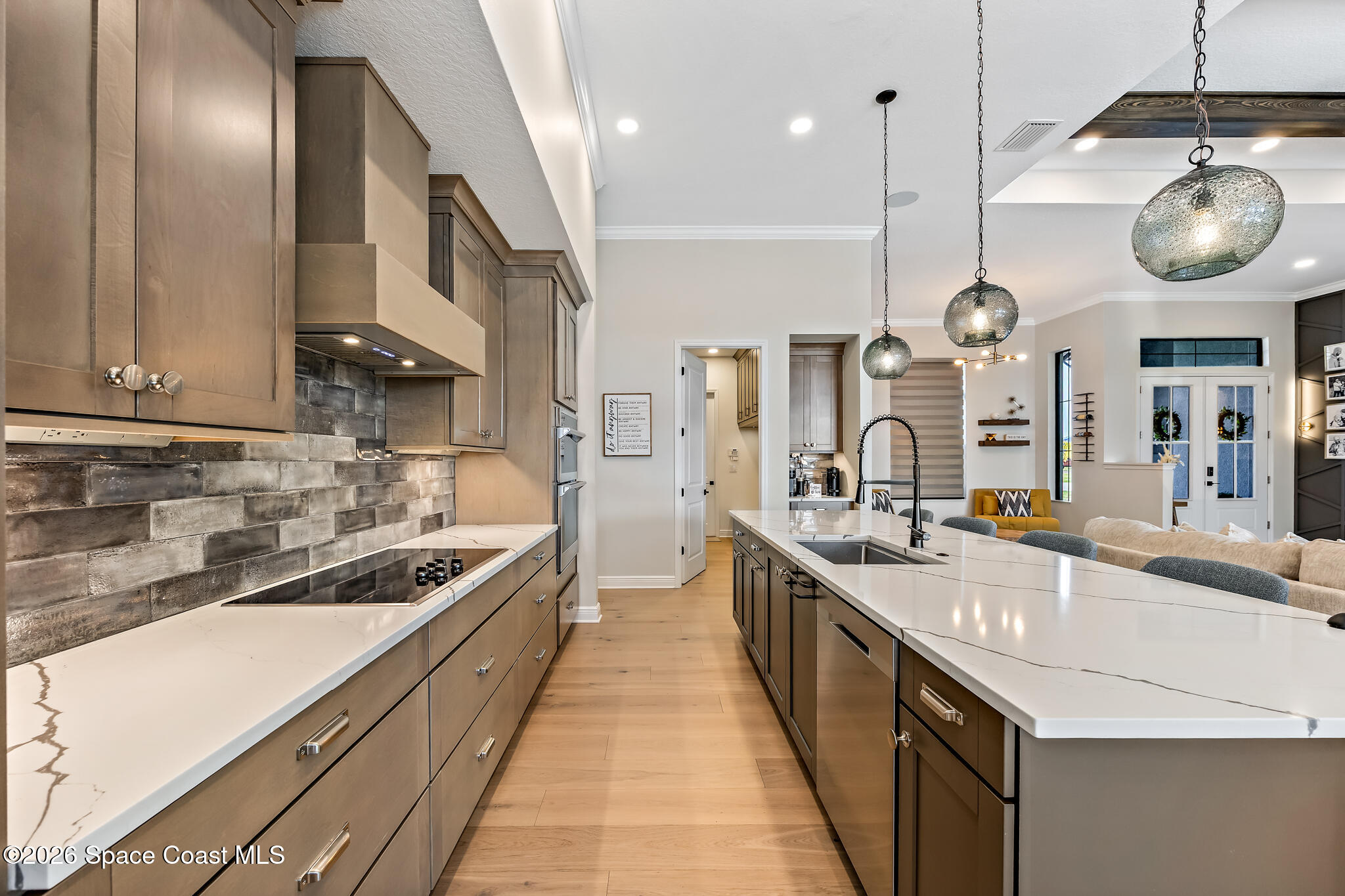 4055 Domain Court Melbourne, FL 32934 - Photo 12 of 49 a large kitchen with stainless steel appliances kitchen island granite countertop a sink a stove and a wooden floors