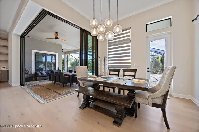 a dining room with furniture and chandelier