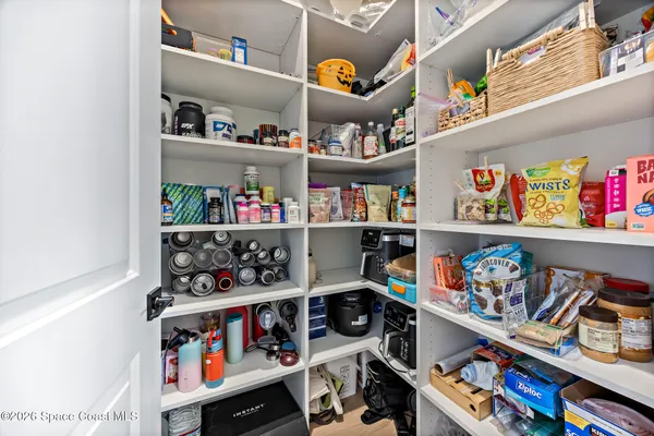 a kitchen with a refrigerator a stove and a sink with wooden floor