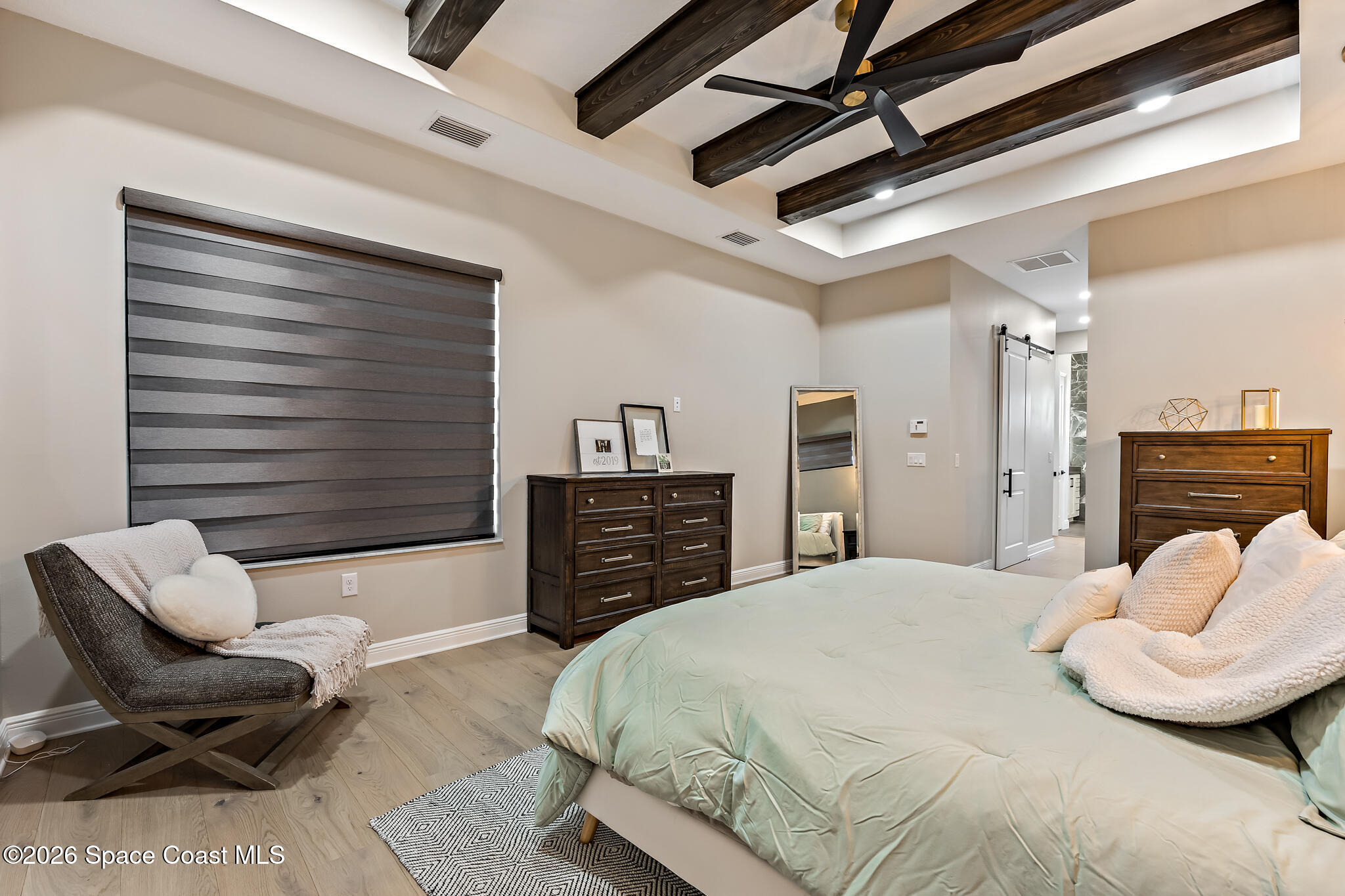 4055 Domain Court Melbourne, FL 32934 - Photo 23 of 49 a bedroom with a bed and a couch