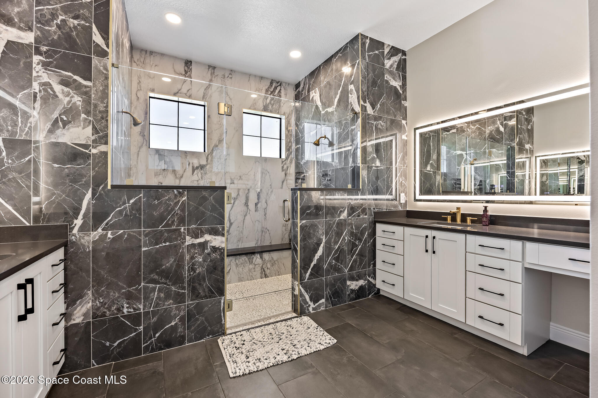 4055 Domain Court Melbourne, FL 32934 - Photo 25 of 49 a spacious bathroom with a granite countertop sink and a mirror