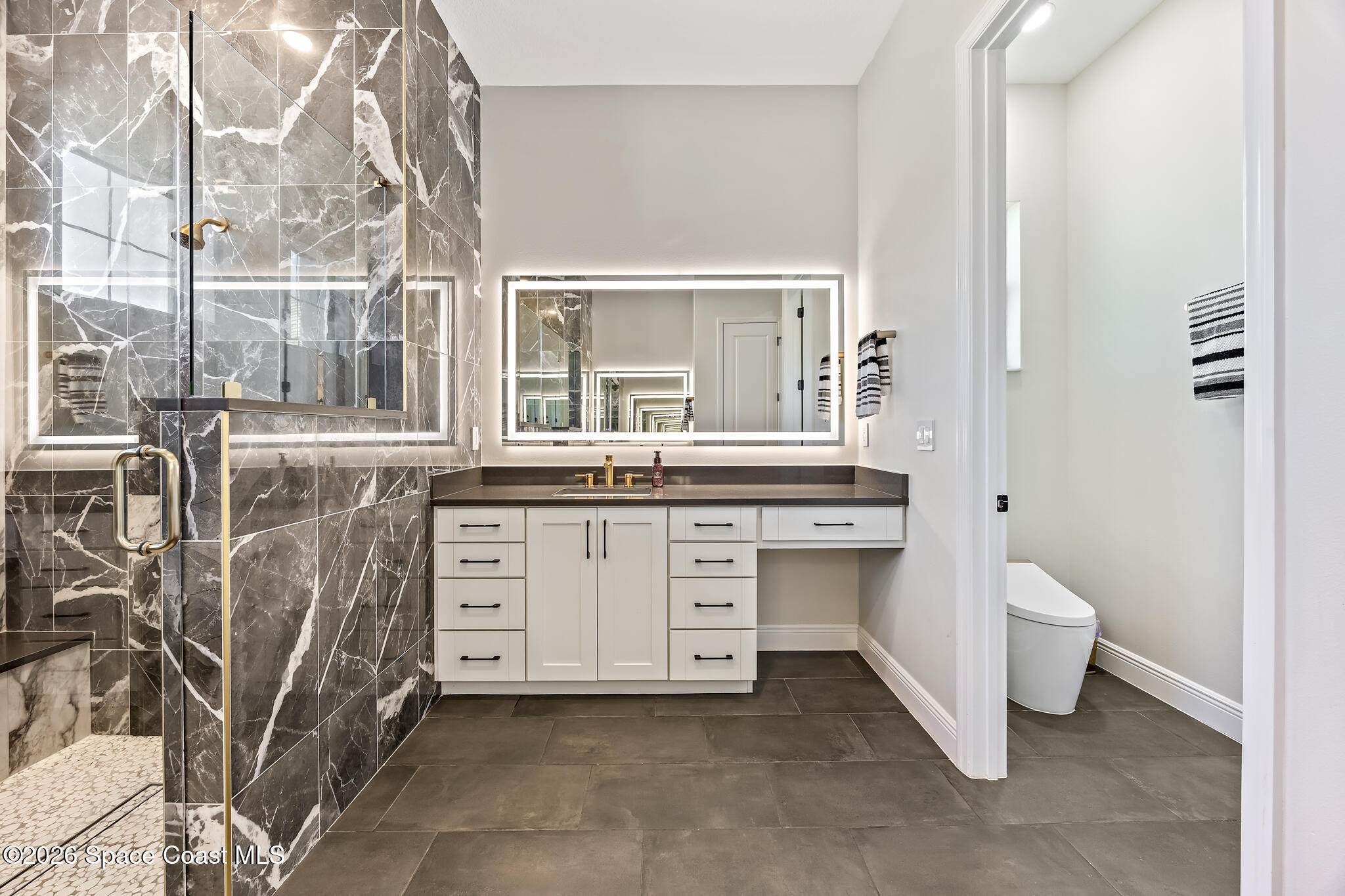 4055 Domain Court Melbourne, FL 32934 - Photo 27 of 49 a bathroom with a double vanity sink a toilet and a tub