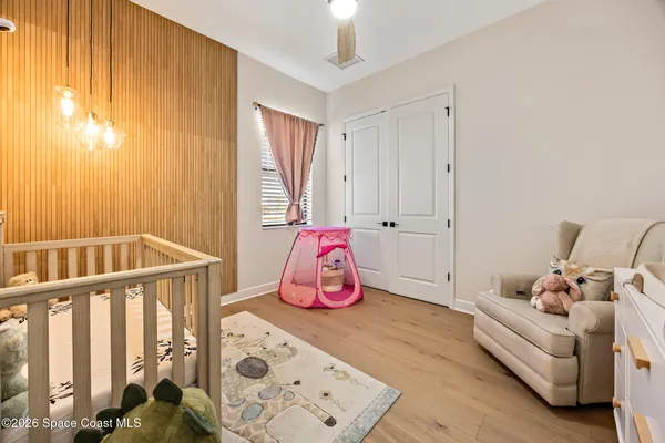 a bedroom with furniture and wooden floor